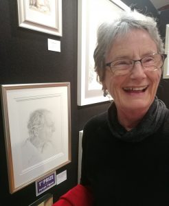 Keri Webb in front of her drawing of her husband dave | Art News Gold Coast | Lucinda's Studio