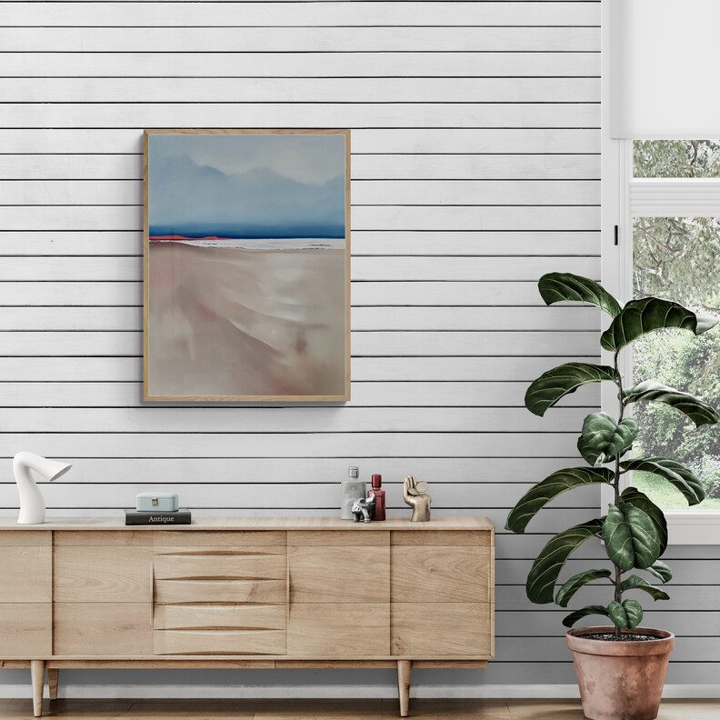 An Australian coastal landscape painting that captures that serene and almost magical silence that envelops the beach at dusk. Soft blues in the sky and sea with a long beach leading to the ocean
