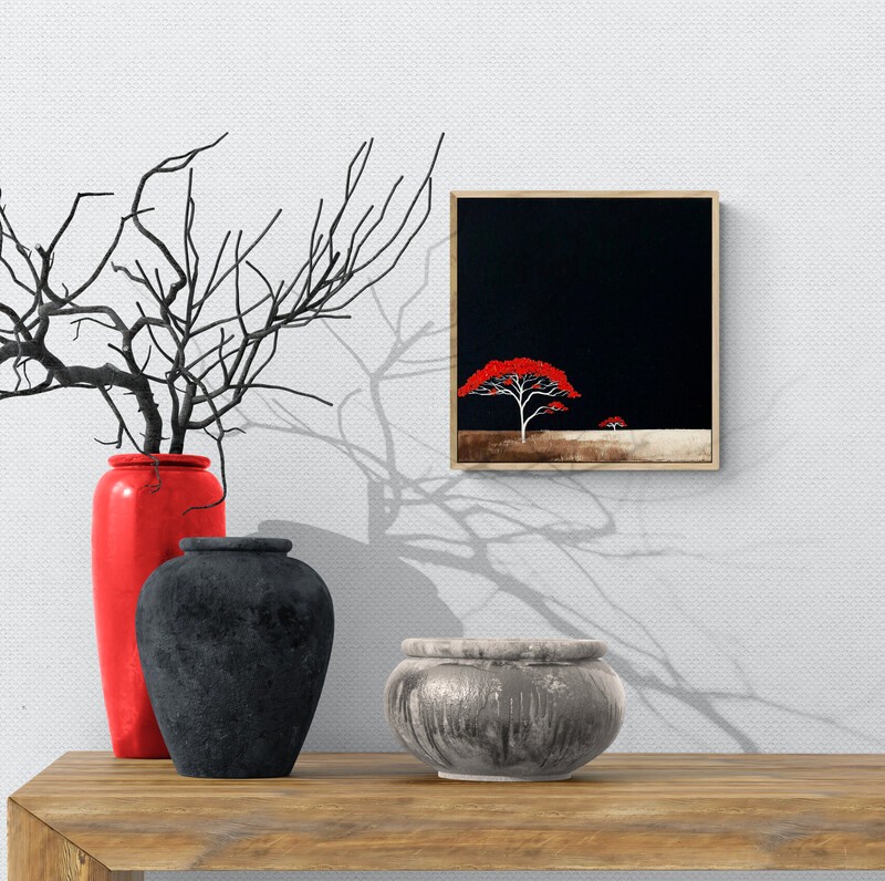 Original Australian landscape oil painting by Lucinda Leveille featuring a single red tree with white branches against a dark sky, minimal horizon and textured earth, framed in a natural oak floating frame.