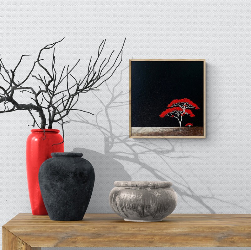 Original Australian landscape oil painting by Lucinda Leveille featuring two red trees with white branches against a dark sky and minimal textured ground, framed in a natural oak floating frame.