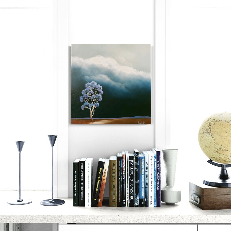 Atmospheric Australian landscape painting featuring a blue jacaranda tree beneath gathering storm clouds and a dark weather-filled sky.