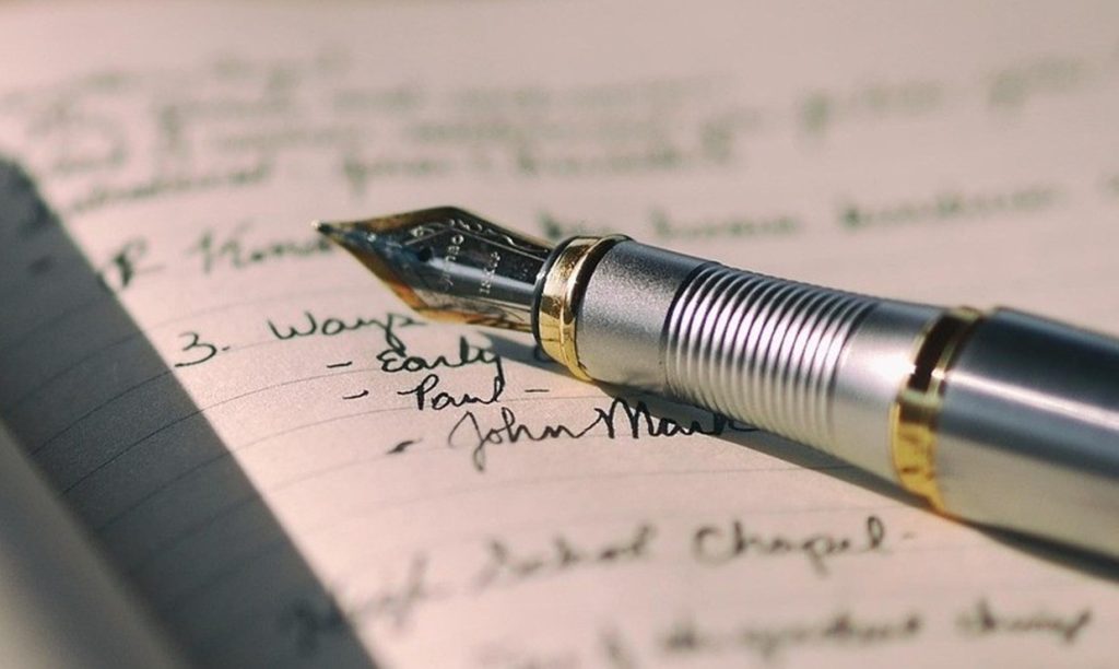 Fountain pen writing in a notebook, representing The Art Diaries by Australian landscape artist Lucinda Leveille.